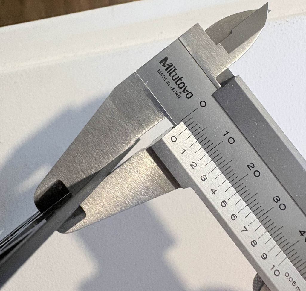 Measurement of a cut Acetal sheet advertised as 1/16 inch